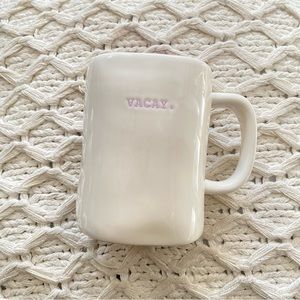 Rae Dunn VACAY typewriter print mug. PURPLE writing and PURPLE inside
